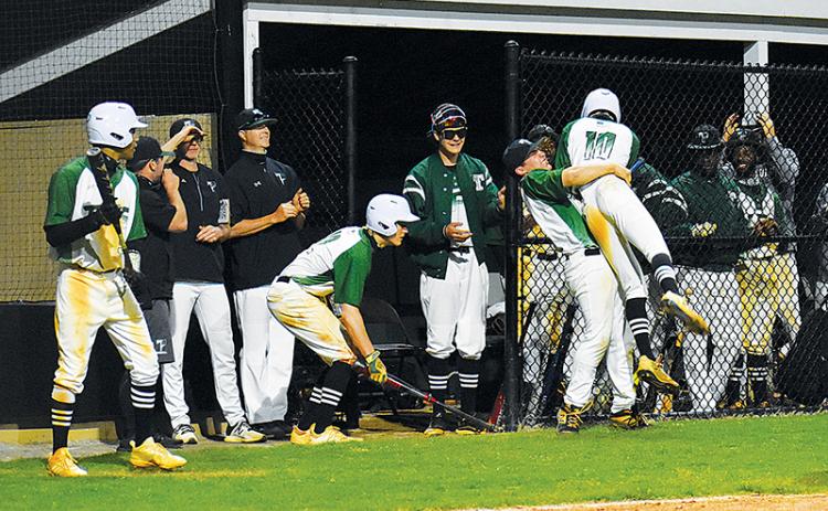 Tallulah Falls’ Tyler Popham gets a hug from Tate Shaw after scoring a run against George Walton on Tuesday.