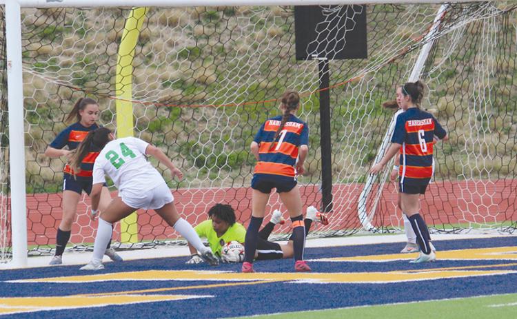Nykerrah Brown dives to smother a shot from a Buford forward during Tuesday night’s contest. Brown recorded several saves to keep the Lady Raiders within striking distance in the first half.