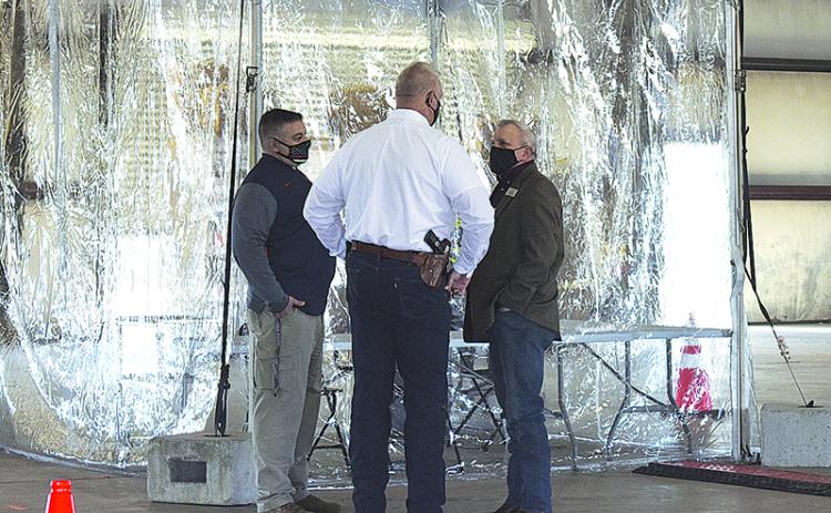 Habersham County Sheriff’s Lt. Murray Kogod, Sheriff Joey Terrell and Habersham County Commissioner Tim Stamey talk over the logistics of the mass vaccination site in Clarkesville when public officials toured it on Feb. 19.