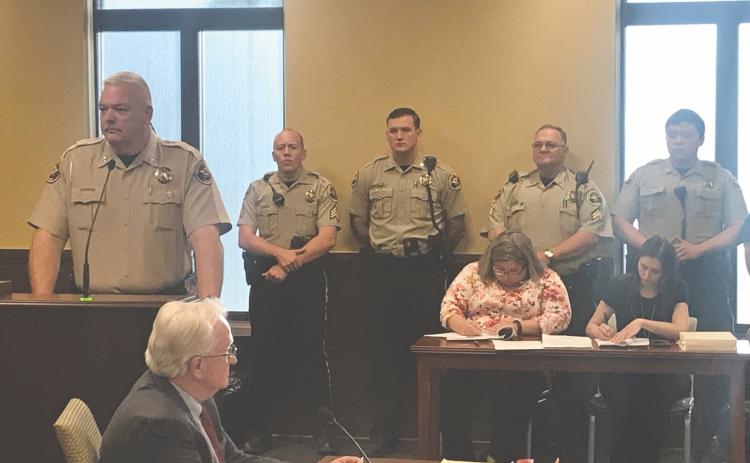 Sheriff Joey Terrell (left) appeared at Monday’s county commission meeting to plead for help with staffing his department, as there are 18 open positions on the force. He was joined by several officers, including (from left) Sgt. Ethan Neal, Deputy Tyler Moon, and Cpl. Brian Collins.  Deputy Dakota Nguyen (out of frame right) and Lt. Travis Jarrell (obscured behind the sheriff) also attended to show their support.
