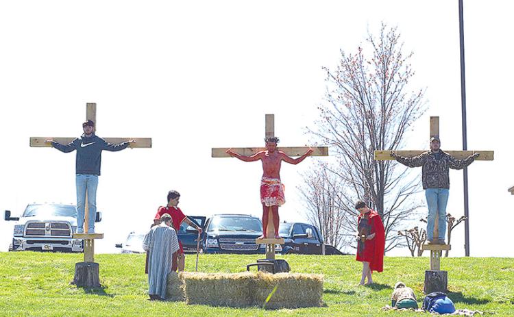 Nick Daunch, one of the participants who played Jesus last Friday, is shown with his brothers, Luke and Noah Daunch, playing the two thieves. Marcus Herrera and Jack Butterworth played the guards.