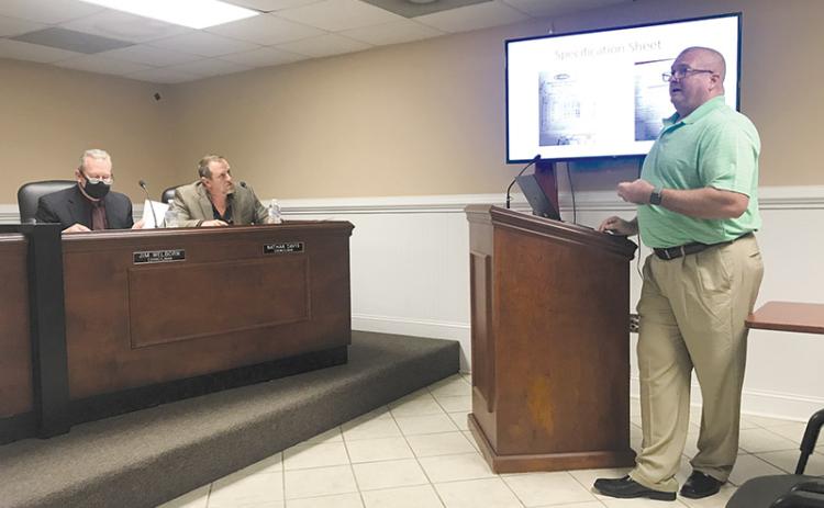 Longtime firefighter Johnny Irvin explains to the Demorest City Council, including Councilmen Jim Welborn and Nathan Davis, his recommendations for a fire truck purchase.
