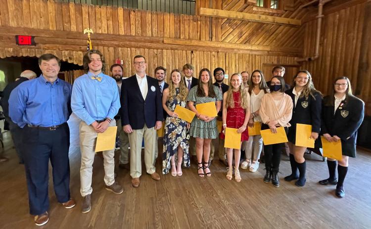 From left at the Rotary ceremony are Rotarian David Foster, Ellis Wallace, Rotarian John Borrow, Rotarian Phillip Smith, Hadden Carswell, Autumn Gattis, Haydn Tatum, Madeline Chosewood, Brian Orozco, Ayla Maughon, Sarabeth Gant, Jessica Armour, Caleb Carter (in back), Abi Coppedge (masked), Sydney Coffey and Anna Waiter. BRIAN WELLMEIER/Staff