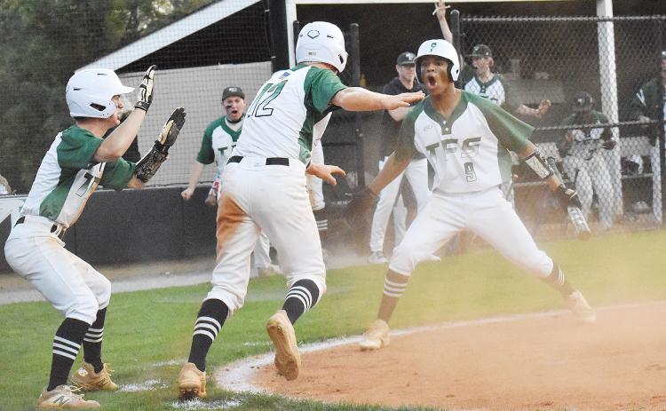 Baylor Carnes, Chathan Clouatre and Malique Charlton celebrate after scoring a couple of late runs in last Tuesday’s game against Athens Christian Academy. CODY ROGERS/Staff
