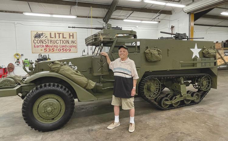Andy Negra took a look at a halftrack military vehicle at Joe Hatfield’s workshop in  Clarkesville on Thursday. Negra drove a  similar vehicle in World War II. BRIAN WELLMEIER/Staff
