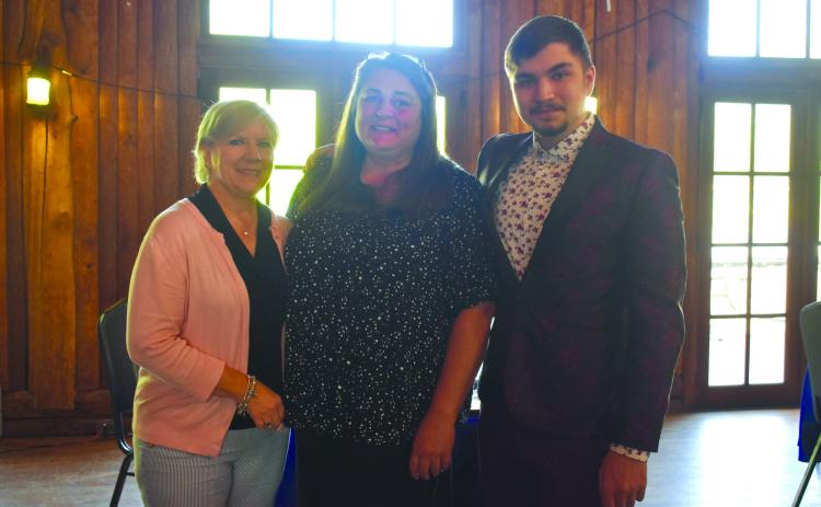 HCHS teachers Angie Nunnally and Gulnur Pendaz smile alongside senior Ege "AJ" Keskin