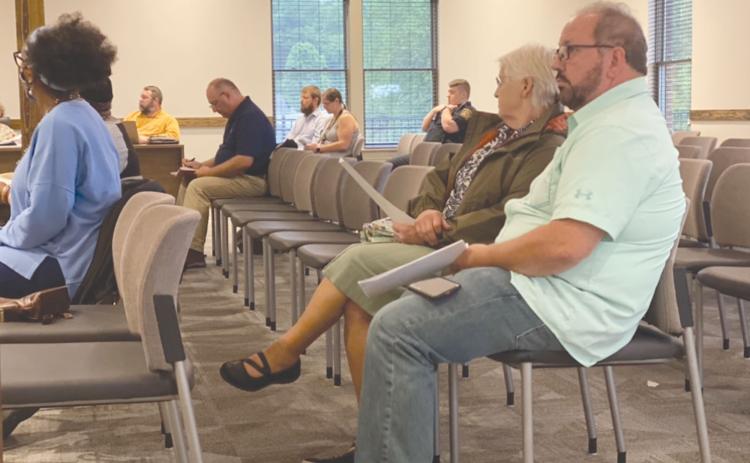 Lifelong Habersham County resident Ernie Garrett, far right, said on Tuesday he has done all he can to stop the erosion on his property from Camp Creek, but he can’t afford to keep taking matters into his own hands. CHAMIAN CRUZ/Staff