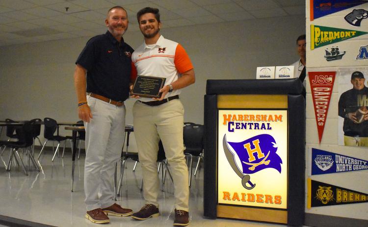 Raiders head coach Benji Harrison (left) presented Hadden Carswell with the Jimmy Williams Courage Award during the Ring of Honor banquet Thursday night. ISAIAH SMITH/Staff