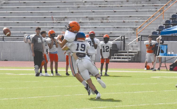 Cole Gragg (19) lays a hit on a receiver in the middle of the field during Wednesday’s practice. ISAIAH SMITH/Staff