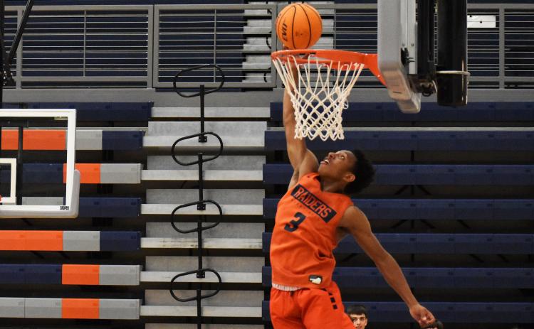 Malachi Dooley elevates and looks to finish an alley-oop during a drill Monday night. ISAIAH SMITH/Staff