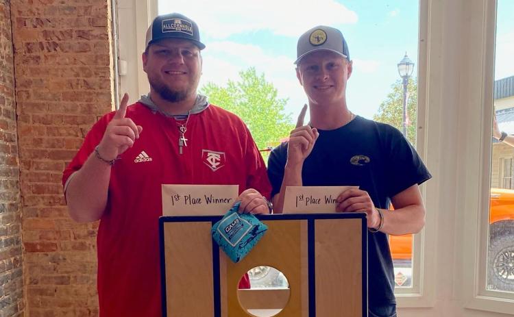 Chase Phillips (left) and Brady Tanner took first place in the Cornelia DDA’s cornhole tournament. The winners received a pair of $100 Visa gift cards and $50 Bigg Daddys gift cards. LINDSEY FITZGERALD/Submitted