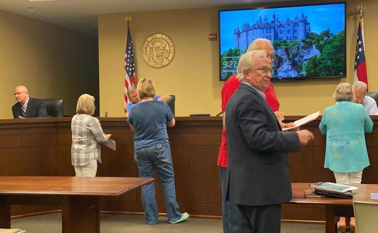 Habersham County Manager Phil Sutton and Habersham County Commissioner Jimmy Tench talk following Monday morning’s airport commission meeting. CHAMIAN CRUZ/Staff