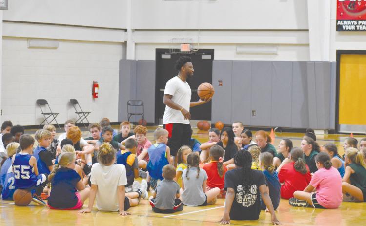 Coach Shamir Dooley speaks to campers following the first day of his MAJ Hoops Championship Skills Camp. ISAIAH SMITH/Staff