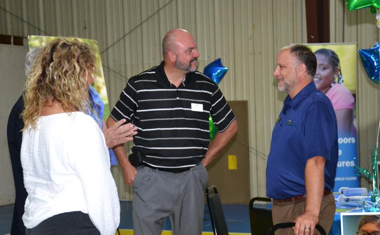 Superintendent Matthew Cooper talks with John Fair, Chief of Staff of Peach State Credit Union, at the Tim Lee Boys & Girls Club open house on June 17. BRIAN WELLMEIER/Staff