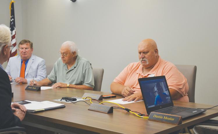 County Commissioners Bruce Harkness, Jimmy Tench and Bruce Palmer hold called meeting before executive session. BRIAN WELLMEIER/Staff