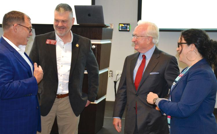 Outgoing County Manager Phil Sutton (second from right) talks with former county commissioners (from left) Stacy Hall, Victor Anderson and Natalie Crawford at Wednesday’s Partnership Habersham meeting, where Sutton was honored by local leaders. MATTHEW OSBORNE/Staff