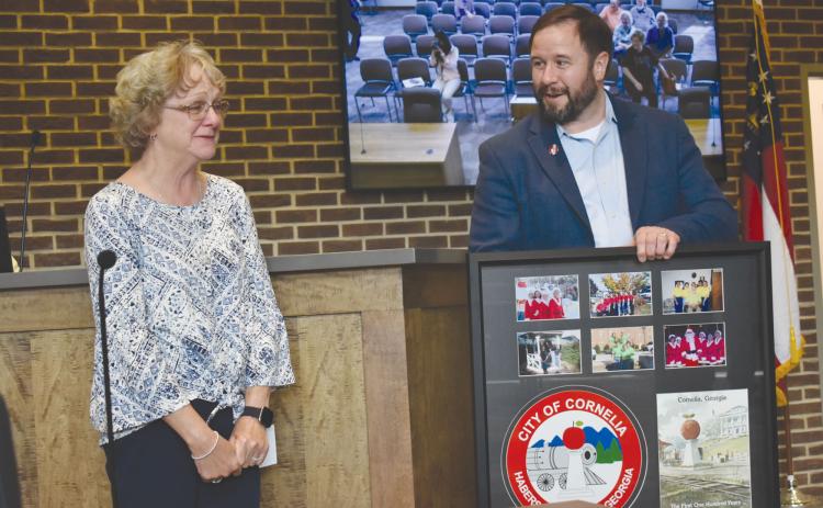 Cornelia Mayor John Borrow presented City Clerk Janie Henderson with a special gift which included a key to the city at Tuesday night’s meeting to honor her 24 years of service to the city. CHAMIAN CRUZ/Staff