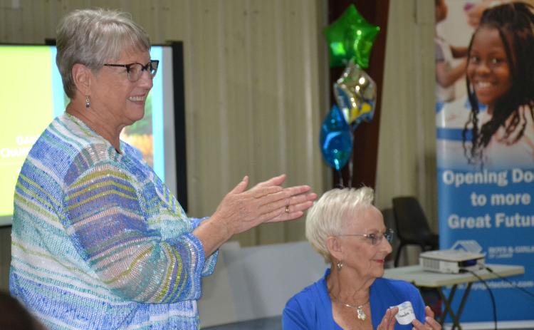 Annette Lee (left) and Sandra Deal applaud a speaker during the open house event Thursday evening for the Habersham County Boys & Girls Club. BRIAN WELLMEIER/Staff
