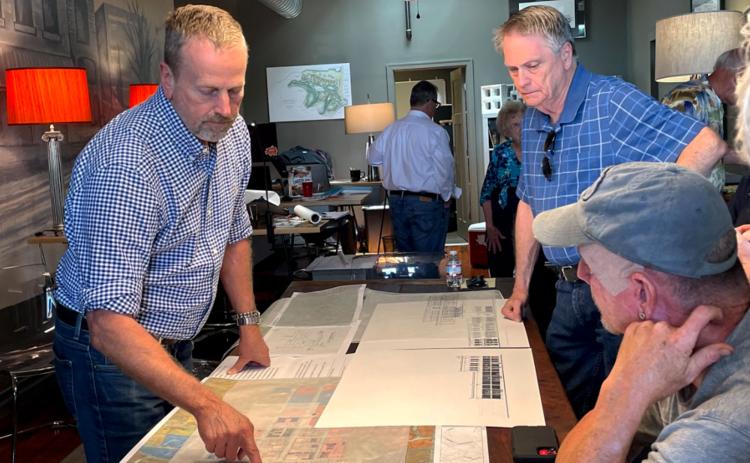 Lew Oliver, Councilman Terry Gladden and Brooks Garcia study map of Clarkesville at a Monday morning meeting. BRIAN WELLMEIER/Staff