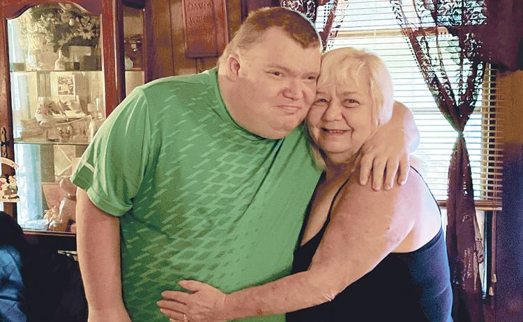 William Wells embraces his mother Judy following her close encounter with death. BRIAN WELLMEIER/Staff