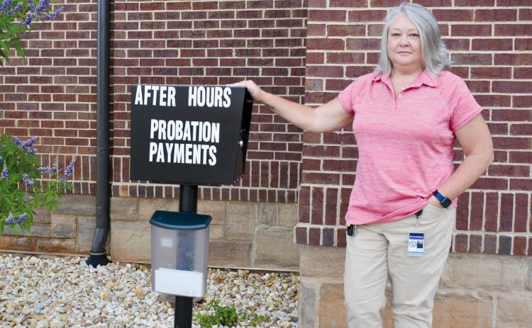 Cornelia Probation Officer Stephanie Smith stands beside the probation fee dropbox outside the Cornelia Municipal Complex. CHAMIAN CRUZ/Staff