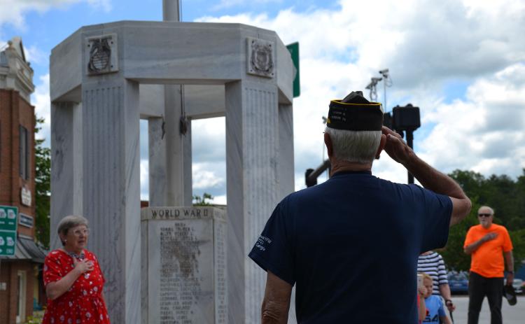 Ray Durham salutes the KIA Memorial in Clarkesville along with Sandra White (left). BRIAN WELLMEIER/Staff