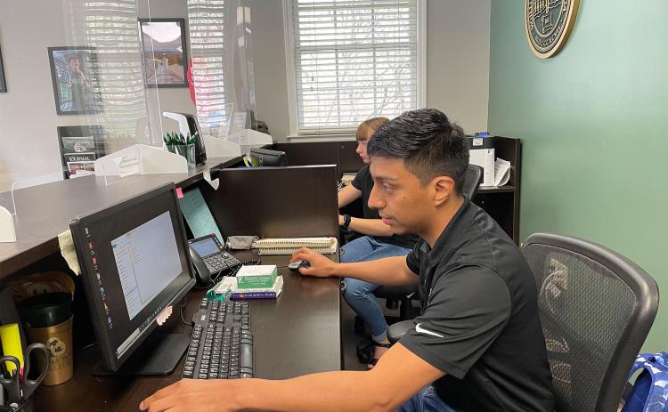 Gabriel Gutierrez works to pull student data at the Piedmont University admission office. BRIAN WELLMEIER/Staff