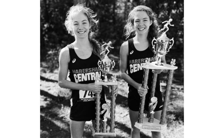 Audrey and Abigail Hotard show off their trophies from last year’s Middle School State Cross Country Championships. Abigail finished first and Audrey finished second in the championship race for all schools competing in the GHSA 5A, 6A and 7A classifications.