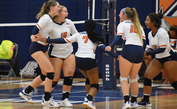 The Lady Raiders celebrate after winning the first match Tuesday night. CODY ROGERS/Staff