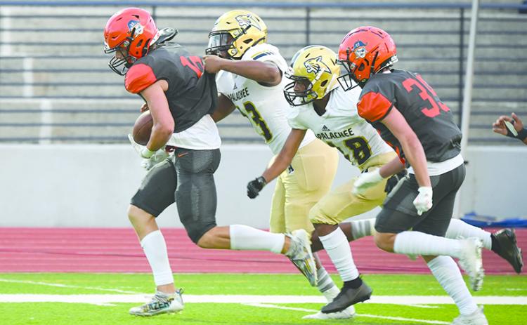 Habersham Central’s Noah Wilson breaks away from Apalachee tacklers after making a catch last Friday night. TOM ASKEW/Special