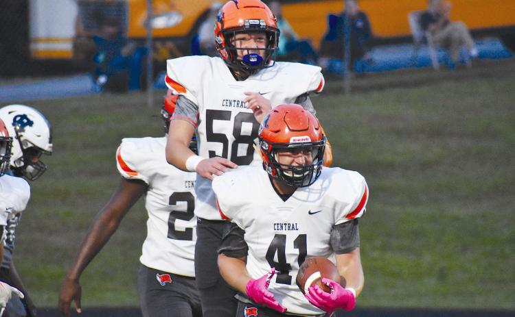 Habersham Central’s Garrett Turner (41) and Jonathan Adams celebrate Turner’s blocked punt touchdown Friday night against White County. MATTHEW OSBORNE/Staff