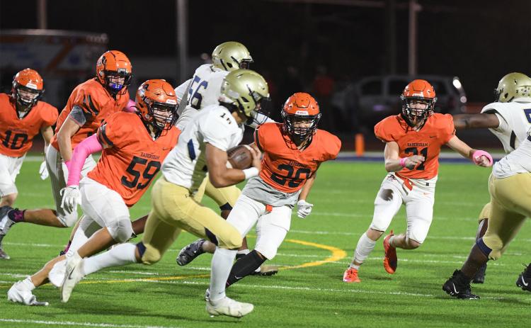 Habersham Central’s Zane Hester (59) Brennon Clouse (20) and Braydon Wright (31) pursue a Dacula ballcarrier on Friday night. TOM ASKEW/Special