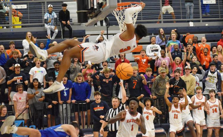 Habersham Central’s Malachi Dooley jams it home in the final seconds of Friday’s win over Banks County, to the delight of his teammates and home fans. CODY ROGERS/Staff