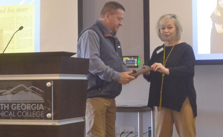 Todd Harper receives the Habersham County Friend of Agriculture award at Friday’s breakfast event from Barbara Rhodes, Habersham Chamber ambassador. BRIAN WELLMEIER/Staff
