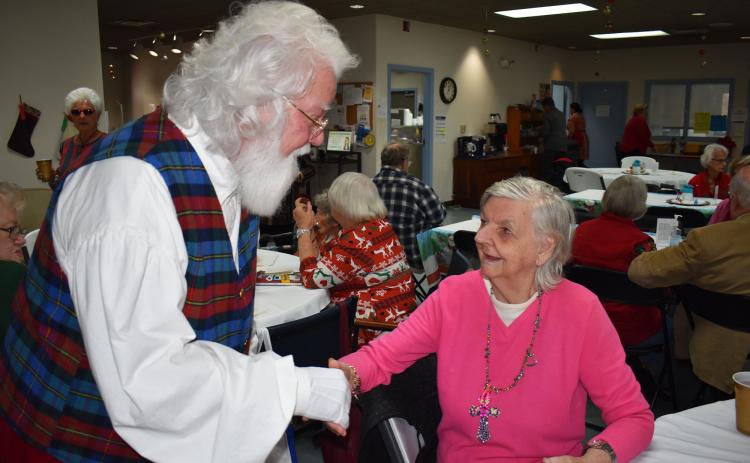 Billy Boyd embraces Senior Center client Helen Dove, who he’d brought a gift to on Thursday. BRIAN WELLMEIER/Staff