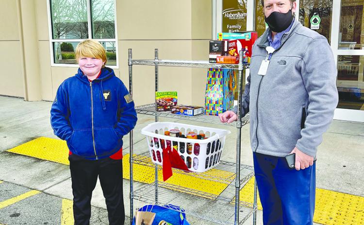 Max Daniel (left) delivers goods he gathered for donation to healthcare workers at Habersham Medical Center, where they were accepted by Matthew Miles. TRICIA HISE/Submitted