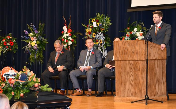 Sawyer  Dover  eulogizes  his father Shane at  Saturday’s memorial service at Habersham Central High School as the Rev. Doug Porter,  Coach Benji Harrison and Dr. Brian James  (obscured) listen in. MATTHEW OSBORNE/Staff