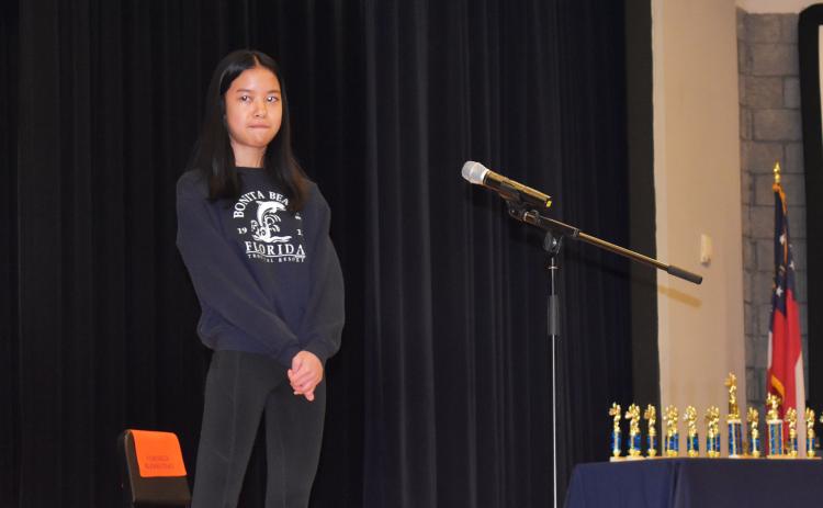 Kayla Nifong of South Habersham Middle School ponders a word during Wednesday morning’s spelling bee. AMARIS E. RODRIGUEZ/Staff