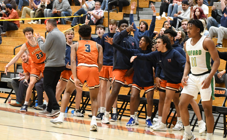 The Raiders bench went crazy after Malachi Dooley hit a three pointer in the second half of the region semifinal game against Buford. CODY ROGERS/Staff