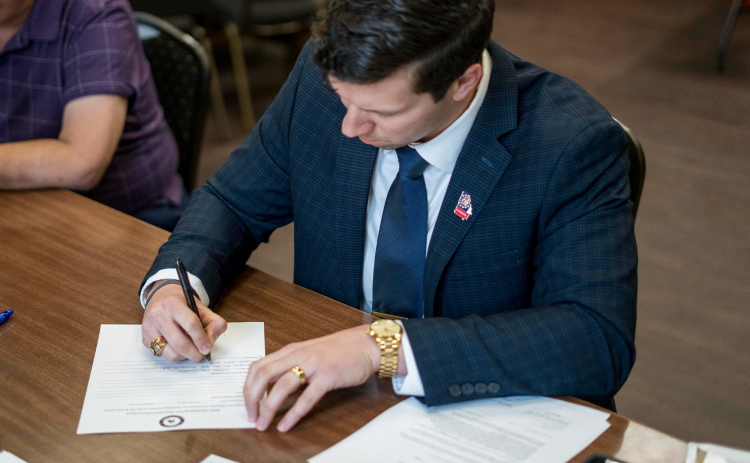 Former Georgia football player Ben Souther signs his paperwork to run for U.S. Congress. Souther is one of four Republicans vying for the seat currently held by U.S. Rep. Andrew Clyde. BRYCE BARRETT/Submitted