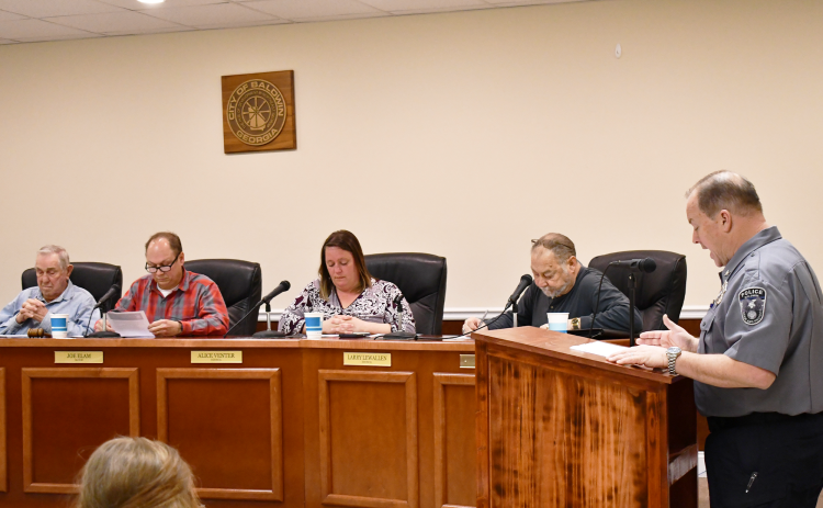 Baldwin Police Chief Jeff Branyon (right) speaks to Baldwin City Counil on Monday night. BRIAN WELLMEIER/Staff