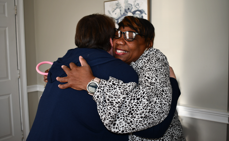 Circle of Hope volunteers Brandy Whitener and Gwendolyn Wiley embrace following a spark of recognition Wednesday. BRIAN WELLMEIER/Staff