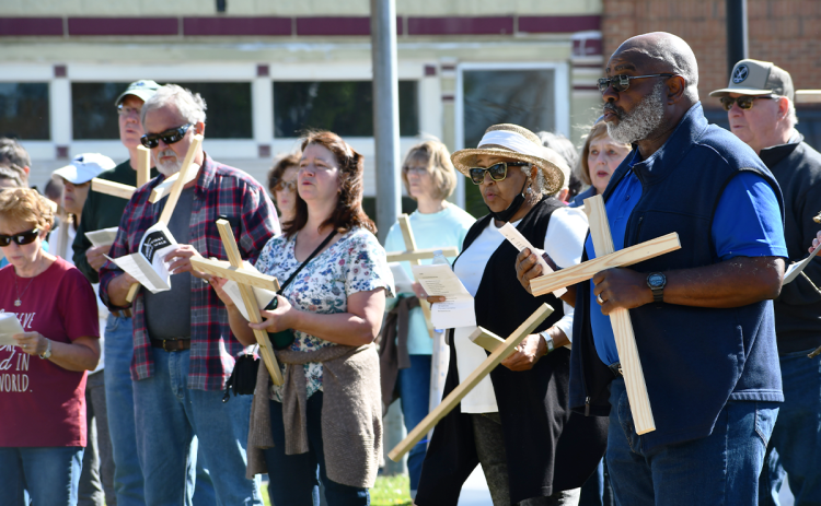 One of the many members of the Good Friday Cross Walk was Mt. Zion Baptist Church Pastor Benjamin Hawks, who is pictured above, on the right, singing with dozens of other walkers who gathered around the Clarkesville gazebo and sang hymns. CODY ROGERS/Staff