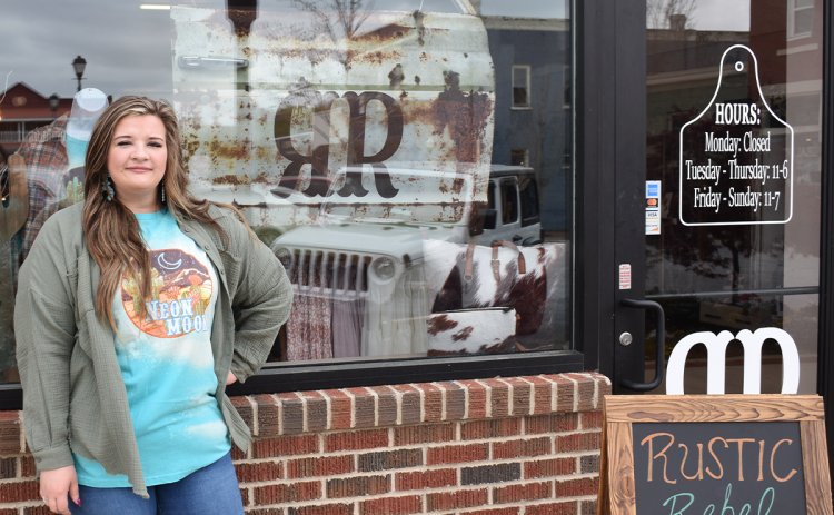 Owner Kayla Clackum flashes a smile as she awaits the grand opening of her first brick-and-mortar boutique, Rustic Rebel Boutique, in downtown Clarkesville on Saturday. AMARIS E. RODRIGUEZ/Staff