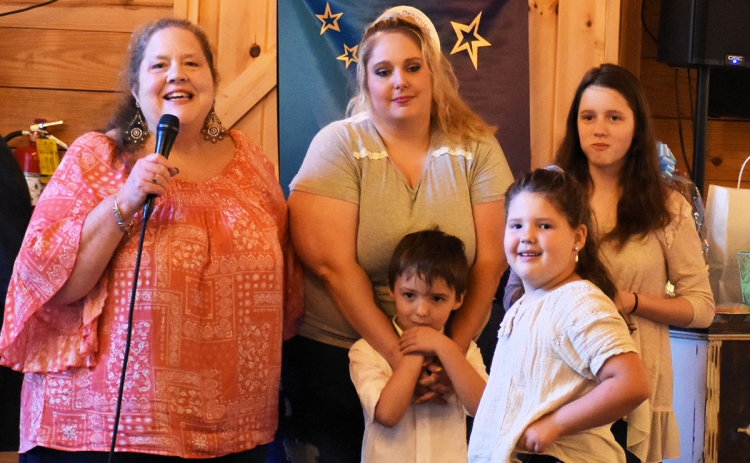 Tam Terrall, Family Services director, confers with a family from the Family Promise program. MARTIE BROOKS/Submitted