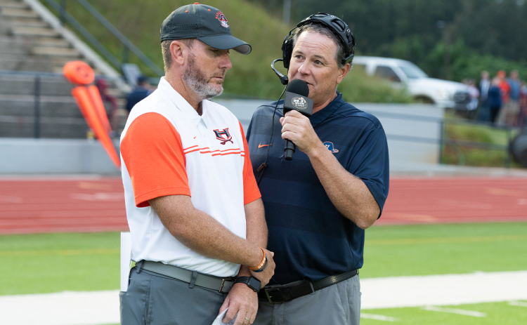 Chris Black (right) gets an interview with Raiders coach Benji Harrison before a big game. Black has been on WCON Radio for 31 years. TOM ASKEW/Special