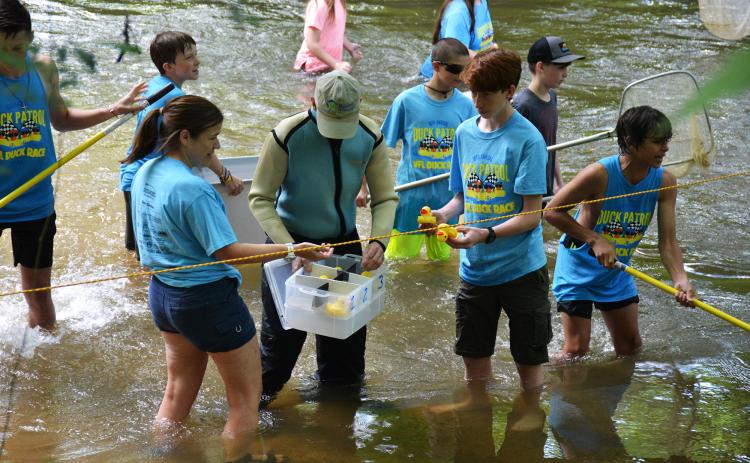 Scouts from Troop 5 fish rubber ducks out of the Soque River during last year’s race.