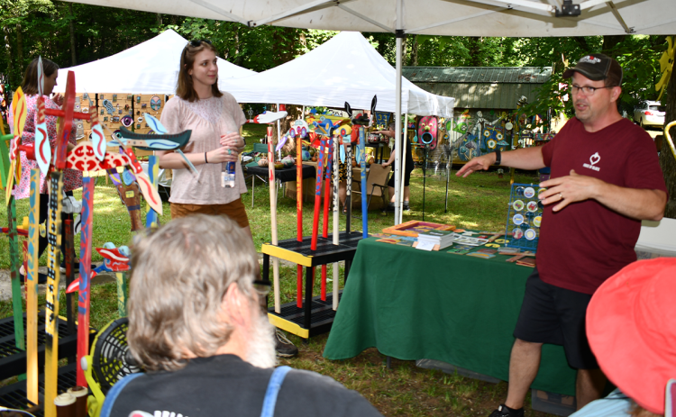 Local artist Kristin Davis (left) interacts with artists Ken Pease (right) and Charlie Dingle (center). BRIAN WELLMEIER/Staff