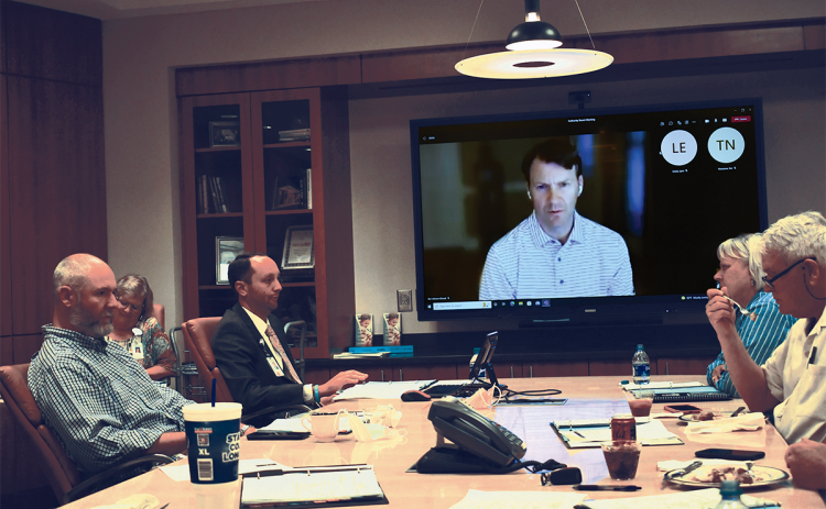 Hospital Authority board member Josh Garrett, CEO Tyler Williams, Ken Johnson (on screen), Chair Dolly Ritchie and Terry Loudermilk discuss business at HMC Tuesday.  BRIAN WELLMEIER/Staff