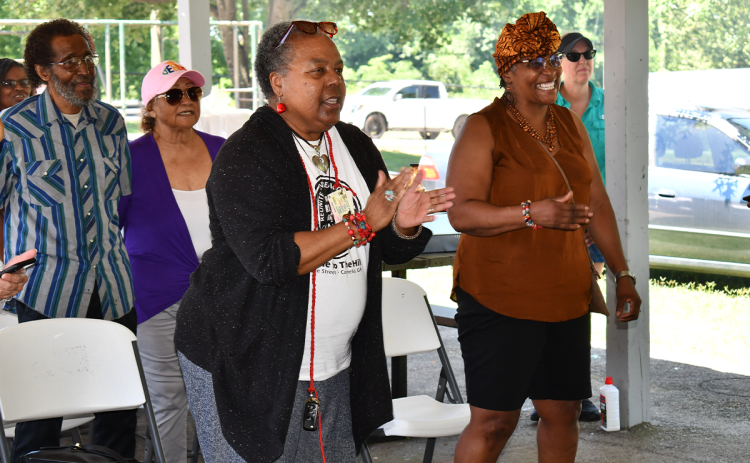 Sandra Davenport and Betty Major sing along to the Black national anthem at the Juneteenth celebration at Jim Smith Park on Saturday. MATTHEW OSBORNE/Staff